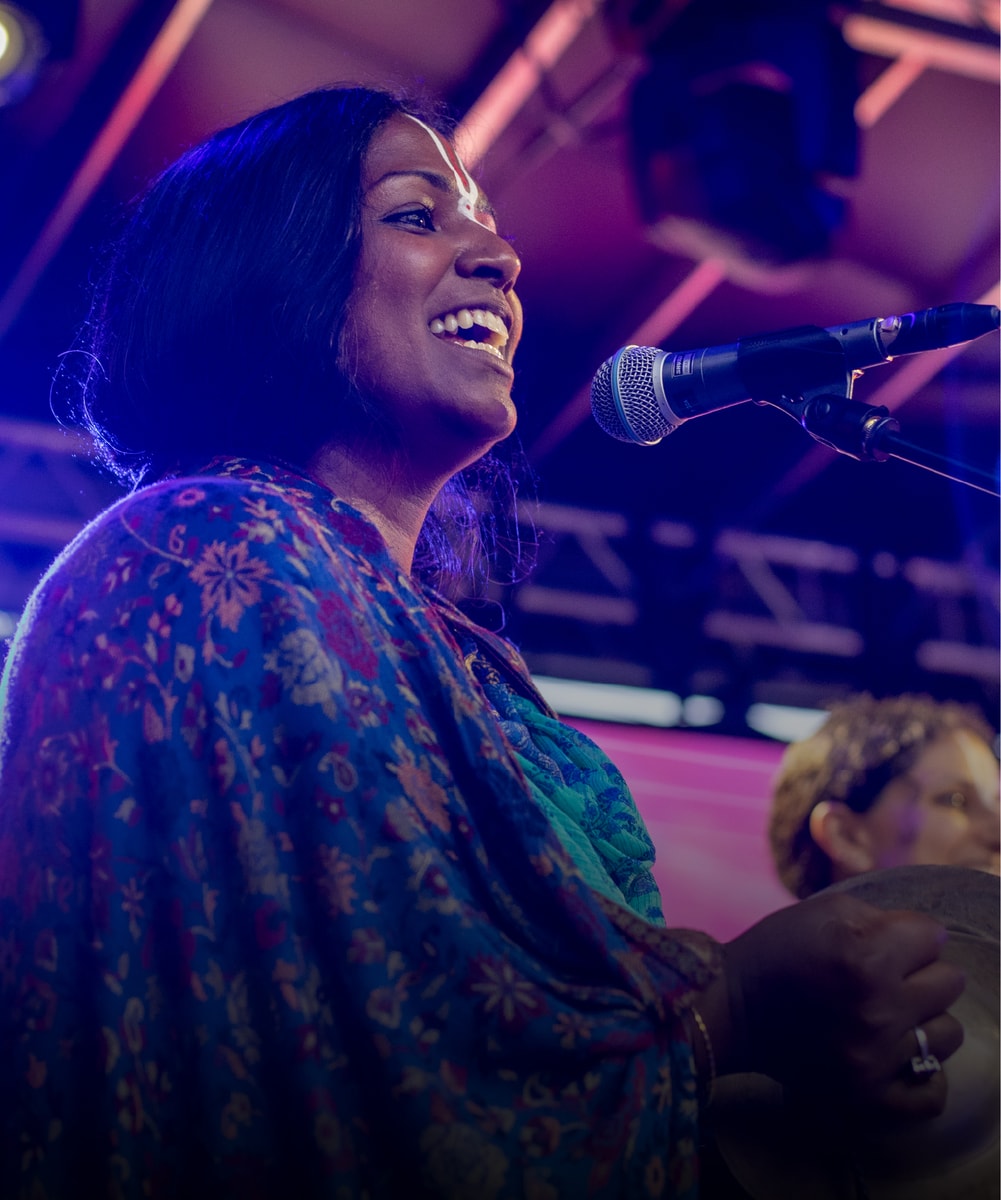 A singer leading kirtan on stage
